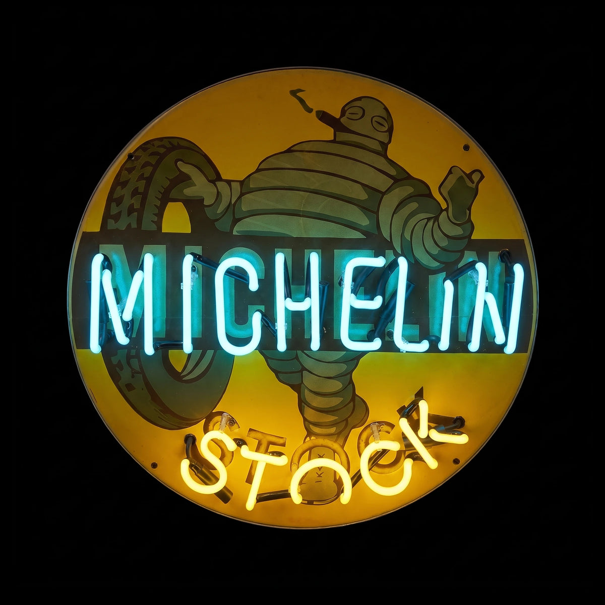 Round 60 cm Michelin enamel neon sign with blue and warm yellow lights on, front view
